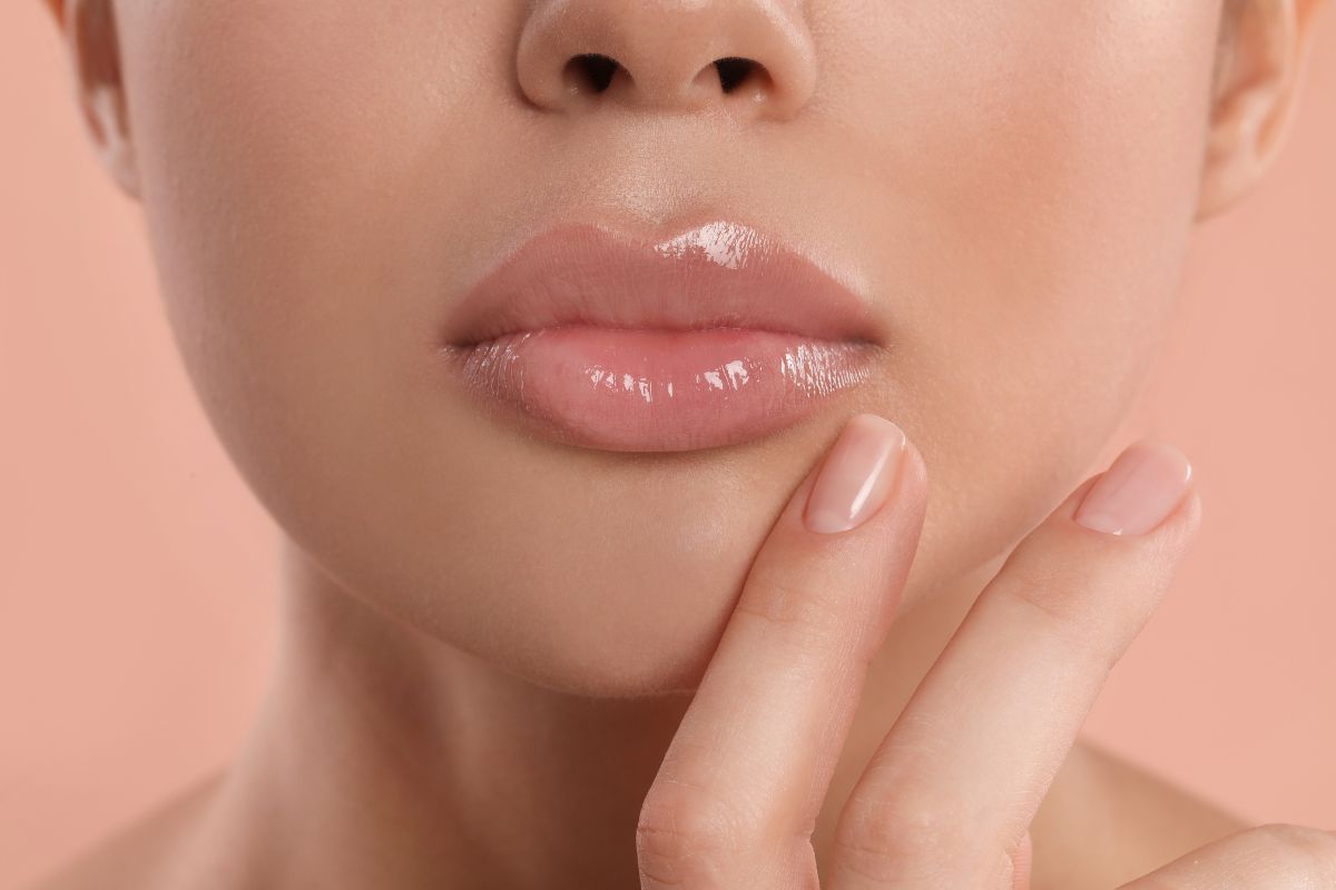 Close-up of full, glossy lips with a natural look, illustrating typical results after stopping lip filler treatments.
