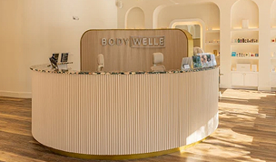BodyWelle reception desk in modern wellness clinic where patients can inquire about monthly EMSCULPT specials.