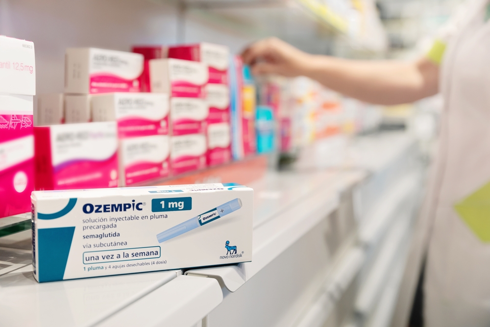 Box of Ozempic 1 mg on pharmacy shelf, highlighting high U.S. cost compared to global prices for weight-loss medications.