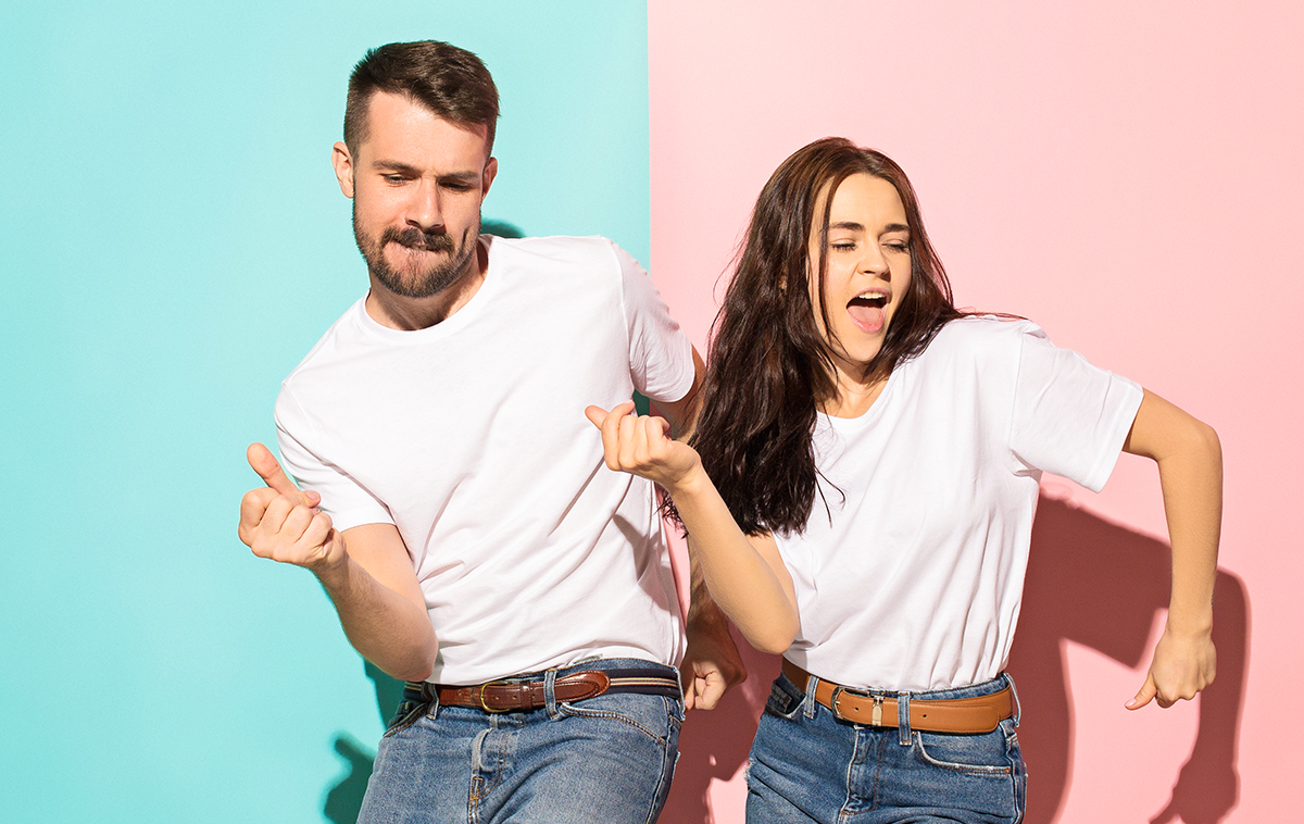 Happy man and woman dancing in casual clothes, symbolizing relief and celebration after securing semaglutide assistance approval.
