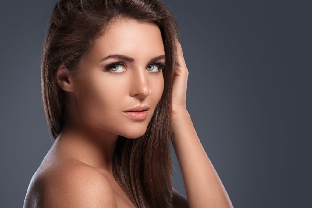 Close-up of a woman with smooth forehead and lifted brows after Botox treatment, showcasing wrinkle-free results.