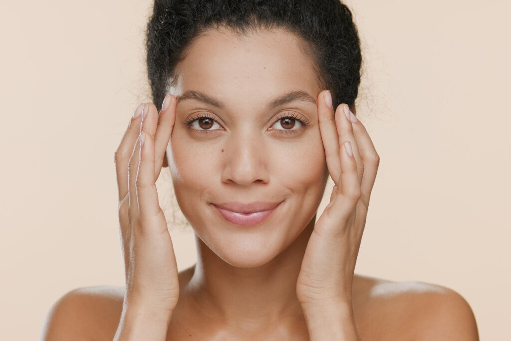 Close-up of a woman with smooth forehead and lifted brows after Botox treatment, showcasing wrinkle-free results.