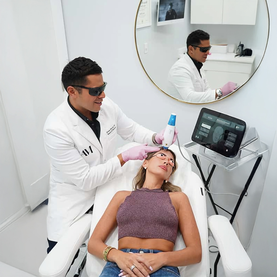 Dr. Alonso Martin performing a Clear and Brilliant laser facial on a patient using advanced skin resurfacing equipment