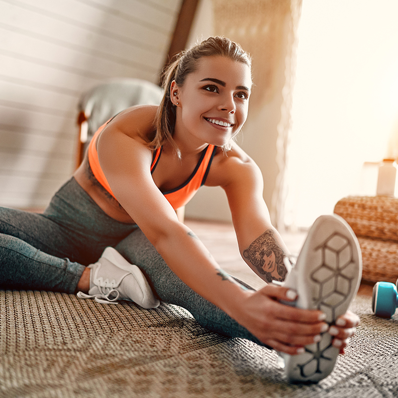 Woman stretching in workout clothes, representing the importance of post-Botox physical activity limitations.