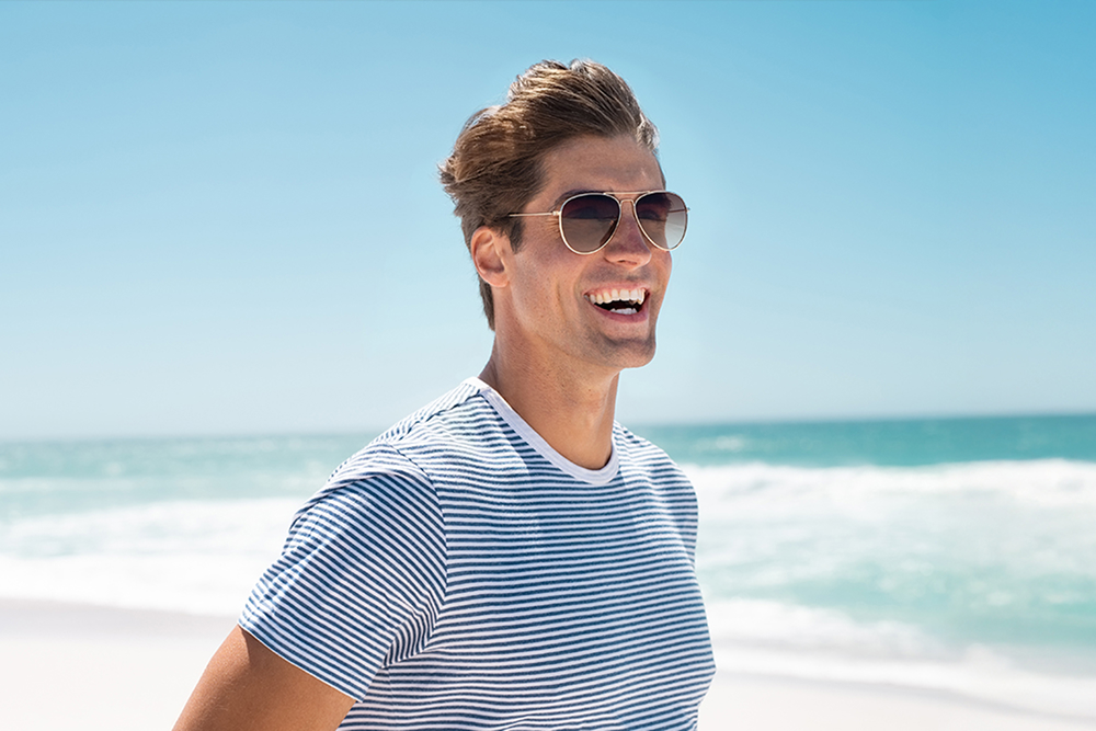 Smiling man at beach with description of stress relief treatment, including supplements, IV therapy, and nootropic spray.