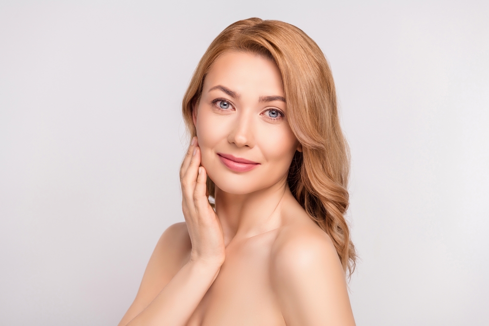 Woman with smooth glowing skin after chemical peel treatment, showing natural rejuvenation results.