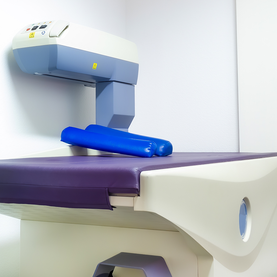 DEXA scan machine in clinic setting used for assessing bone density, fat mass, and lean muscle in body composition analysis