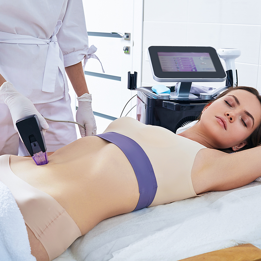 Woman receiving Morpheus8 Body treatment on abdomen to tighten skin and improve texture during in-office session