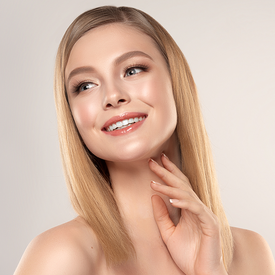 Woman with glowing, smooth skin smiling confidently, representing a suitable candidate for microneedling with PRF