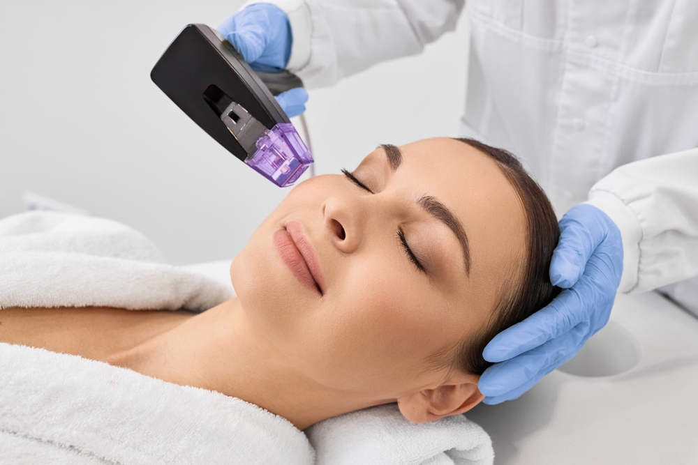 Patient receiving Morpheus8 radiofrequency microneedling treatment by professional wearing gloves, ensuring safe application.