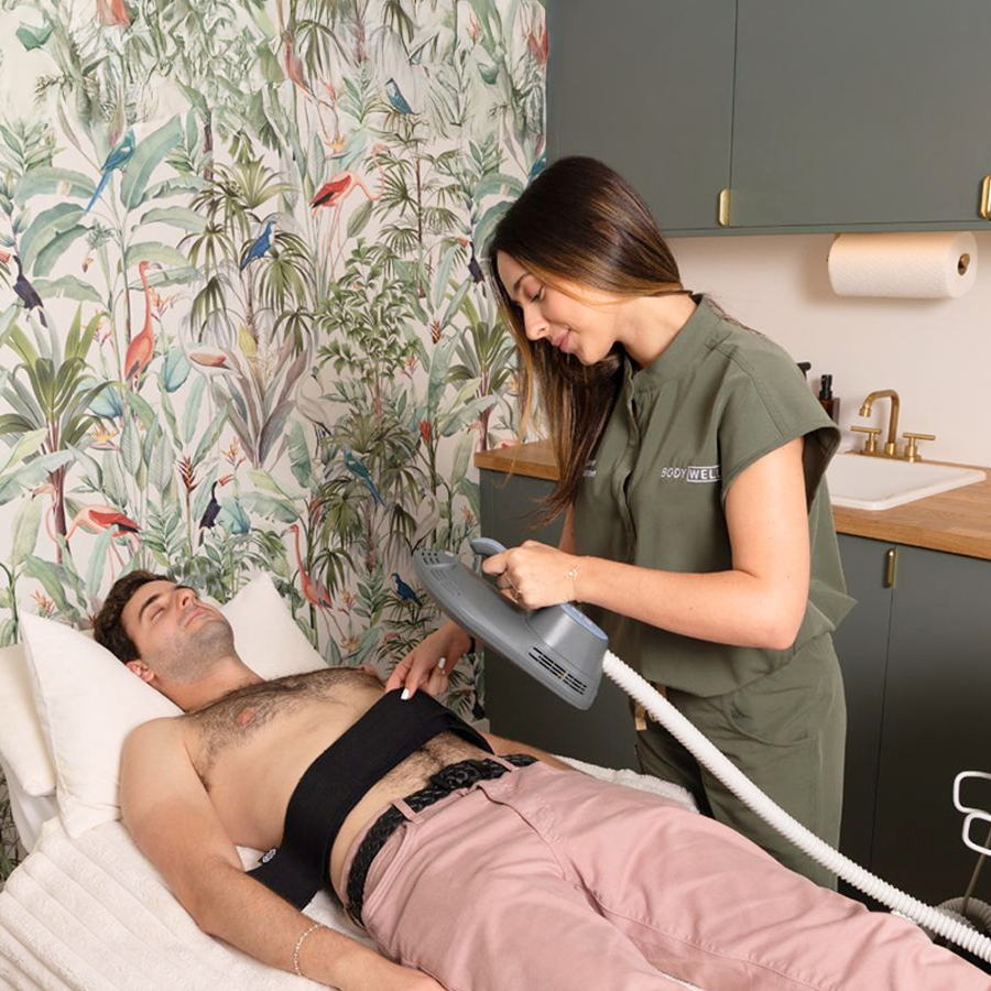 Male patient receiving EMSCULPT NEO treatment on abs to burn fat and build muscle at BodyWelle in Miami Beach.