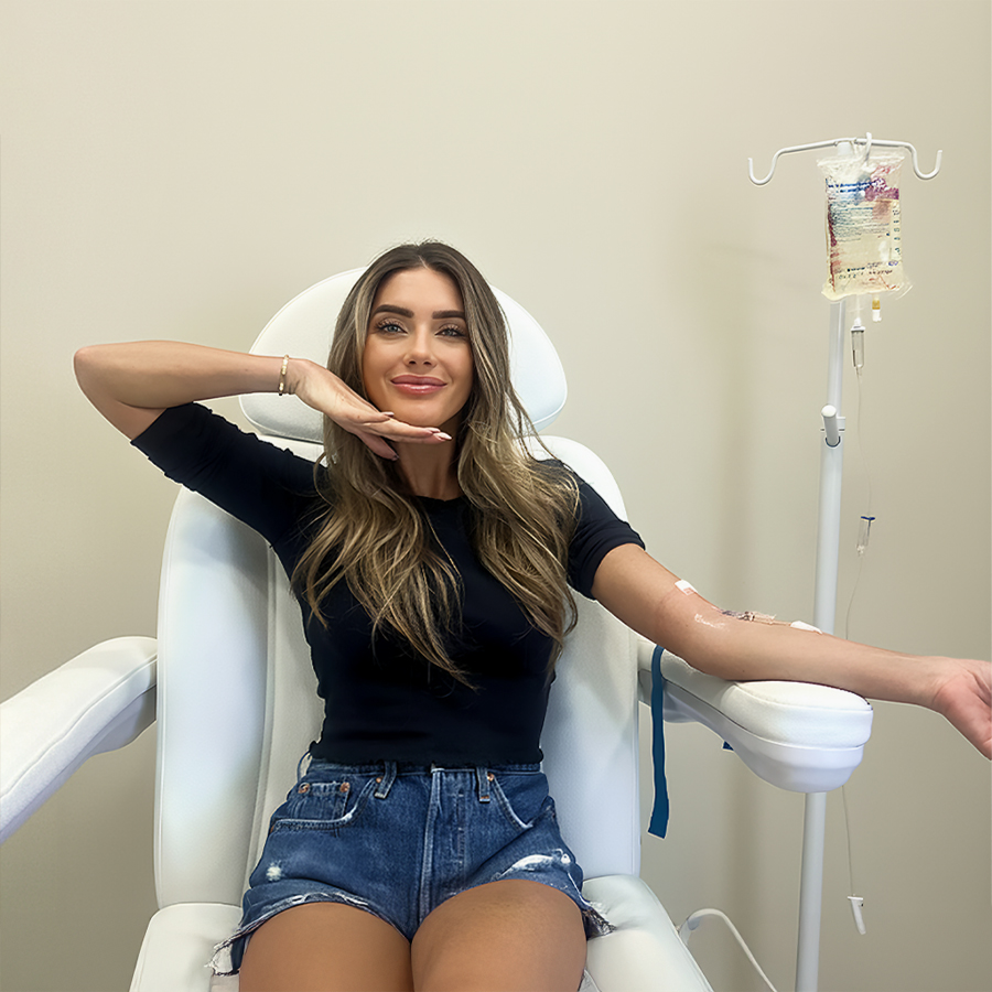 Woman receiving IV vitamin C therapy to boost immunity, reduce oxidative stress, and support cellular health.