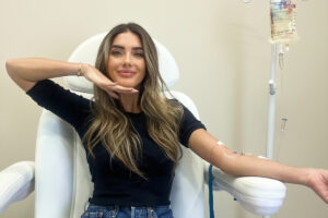 Woman receiving IV therapy while seated comfortably to restore hydration and energy at BodyWelle clinic in Miami Beach.