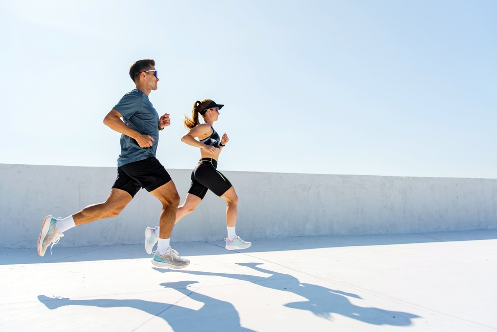 Man and woman jogging outdoors, representing active individuals who may benefit from Energy IV therapy for hydration.