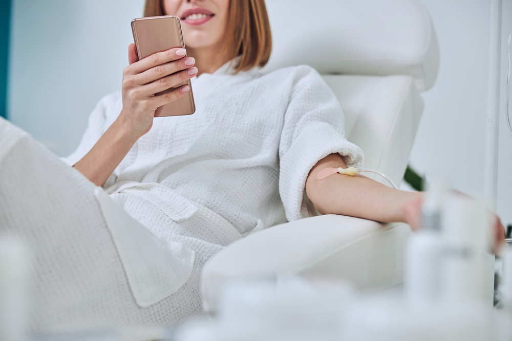 Woman relaxing during Energy IV therapy session, enjoying a simplified alternative to multi-ingredient wellness cocktails.