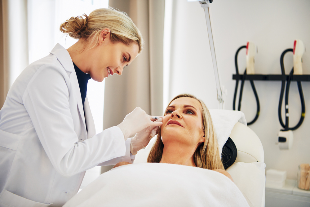 Clinician administering Botox neuromodulator injection to reduce dynamic wrinkles and facial expression lines