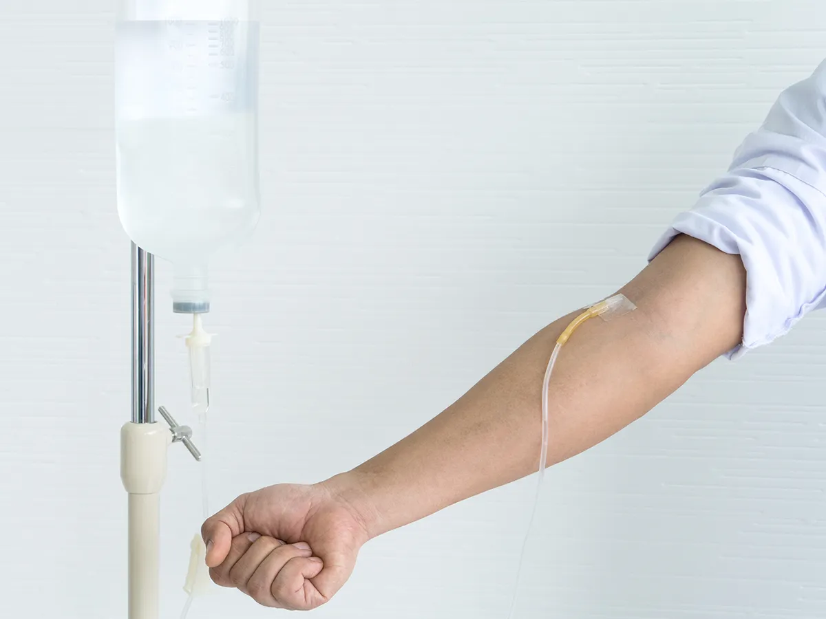 IV line connected to a patient’s arm during infusion therapy.