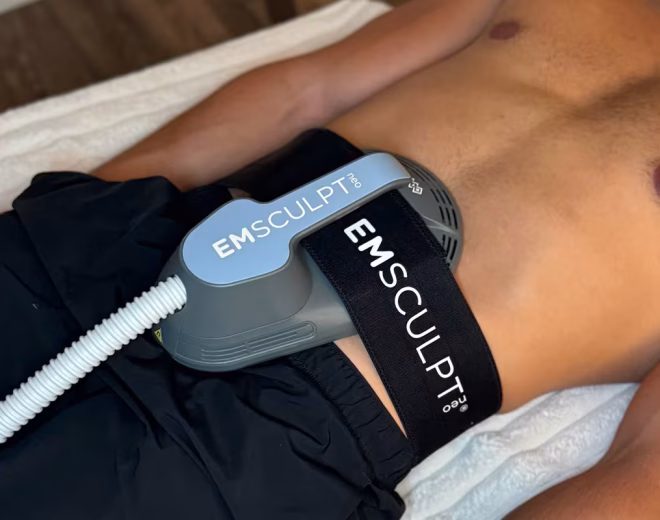 EMSculpt NEO applicator positioned on a patient’s abdomen during treatment.
