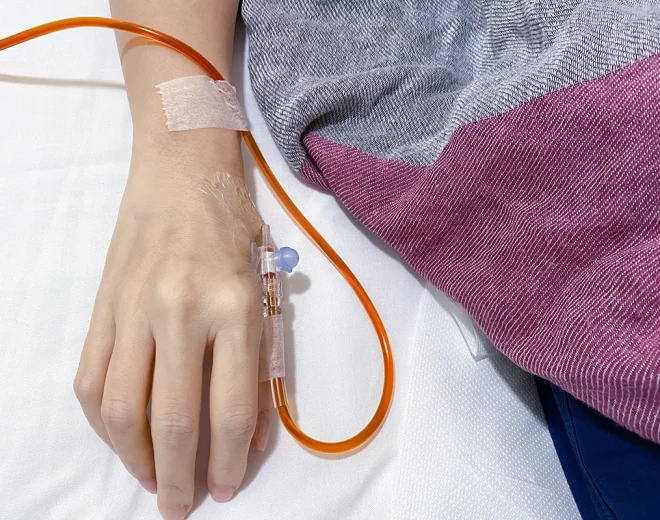IV infusion line connected to a patient’s hand.
