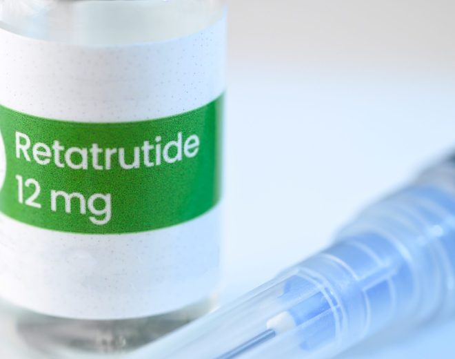 Retatrutide 12 mg vial with syringe on medical surface, representing investigational weight loss medication for obesity treatment.